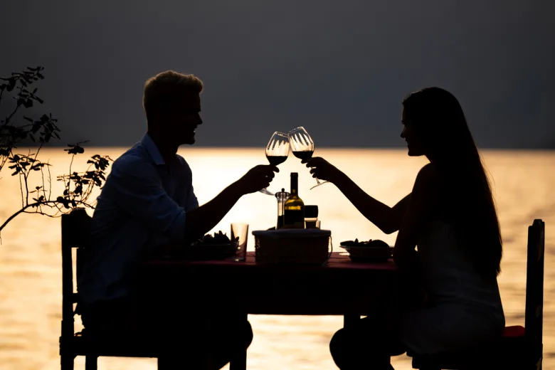 These are things to do in Puerto Vallarta, there are two persons having dinner at the beach